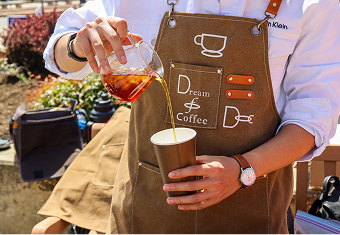 Barista pouring coffee into a cup
